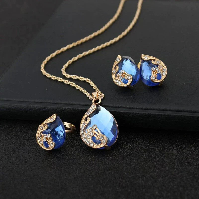 Ensemble collier et boucles d'oreilles pendantes en cristal bleu en or