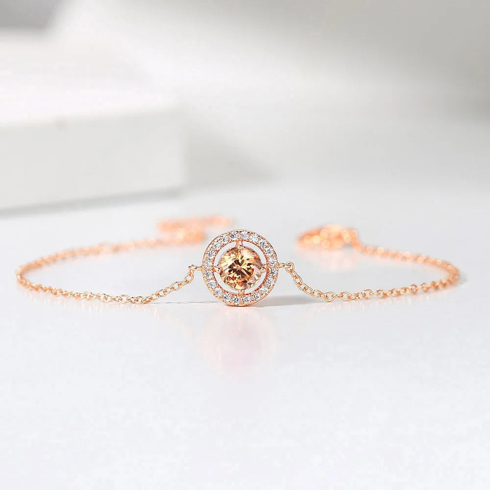 Pulsera clásica de oro rosa con gemas redondas naranjas y borde brillante