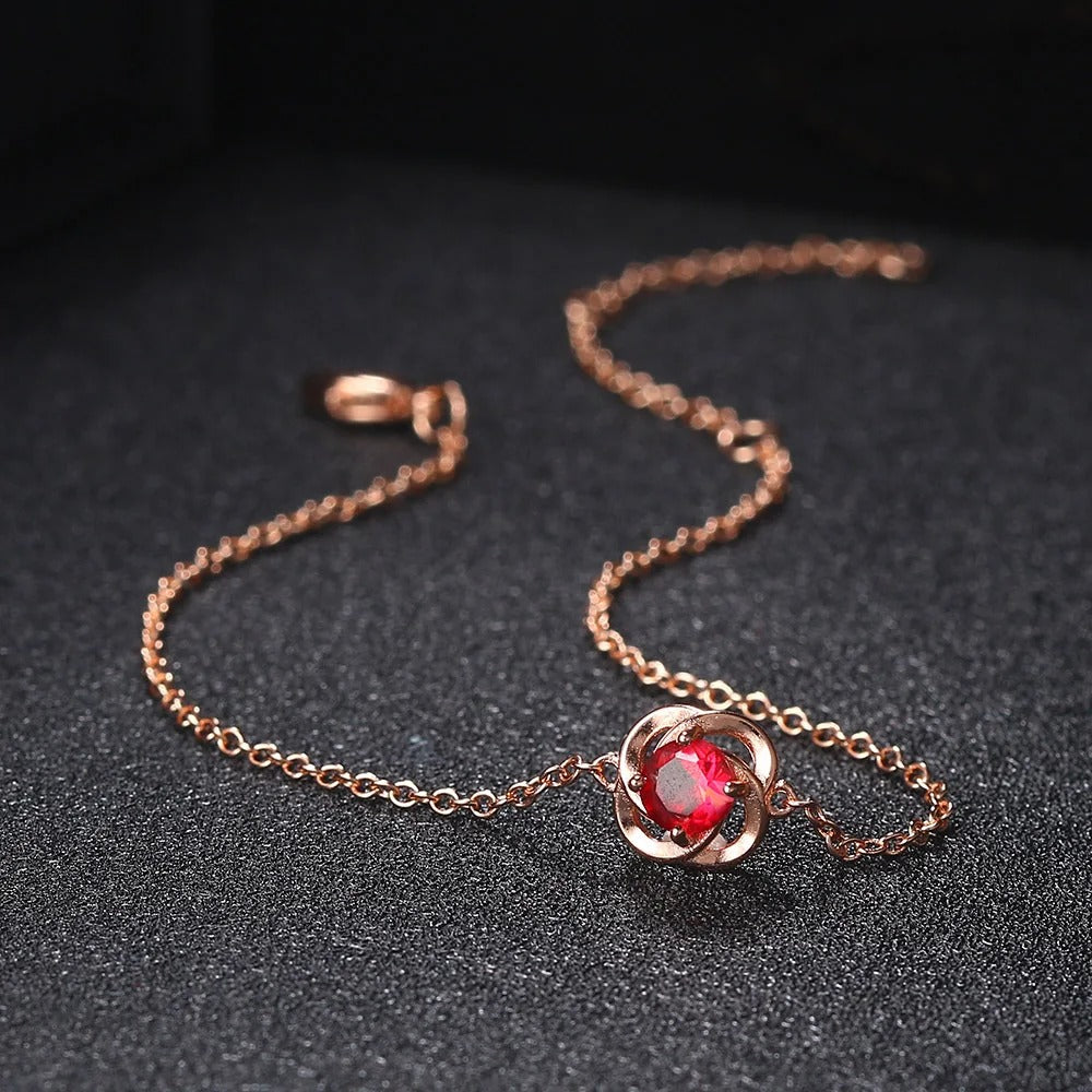Pulsera con colgante de flor de cristal rojo y oro rosa