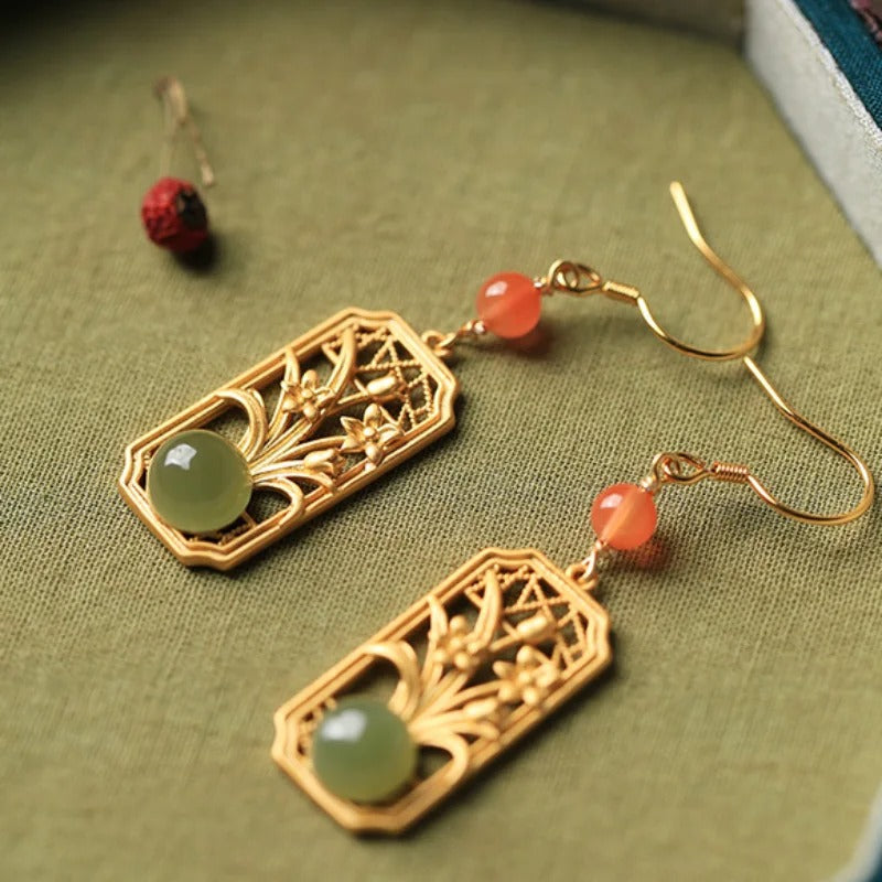 Pendientes vintage dorados con gemas verdes frescas y diseño floral