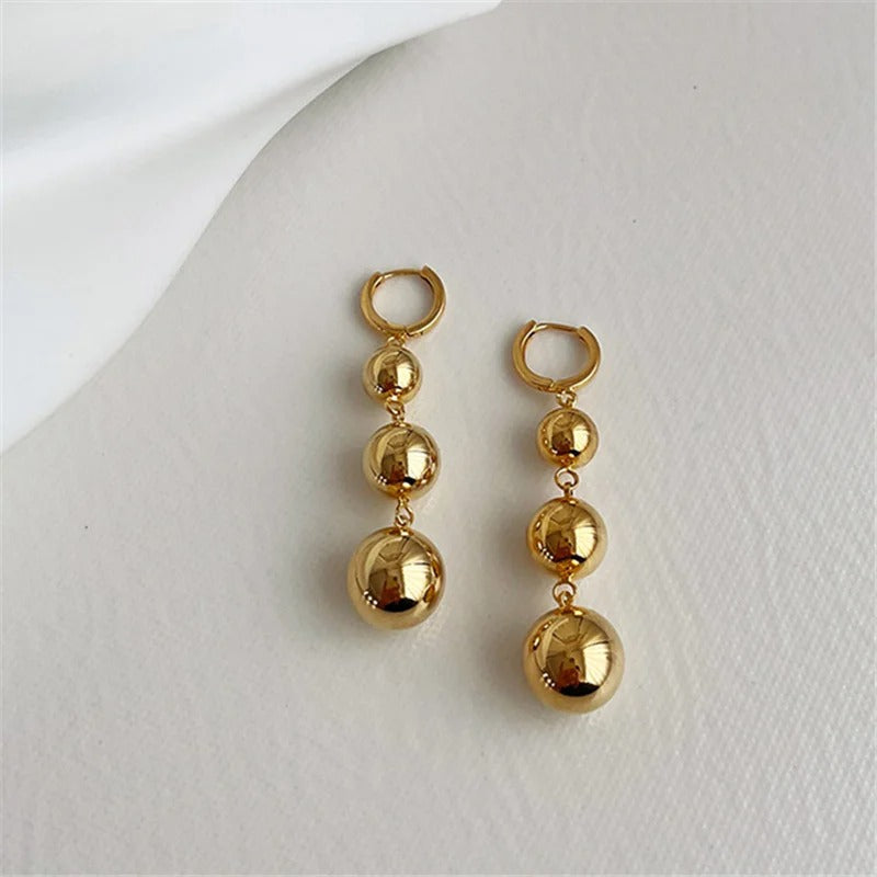 Boucles d'oreilles pendantes à trois boules dorées brillantes