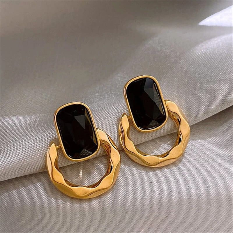 Pendientes de aro con piedras preciosas ovaladas doradas y negras