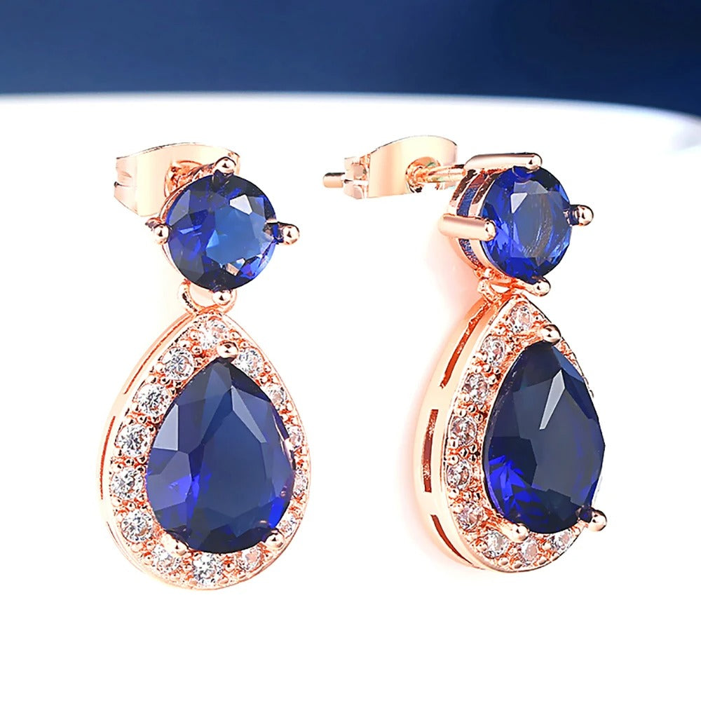 Pendientes colgantes de piedras preciosas azules y blancas en oro rosa
