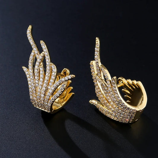 Pendientes de llama alada con brillo dorado